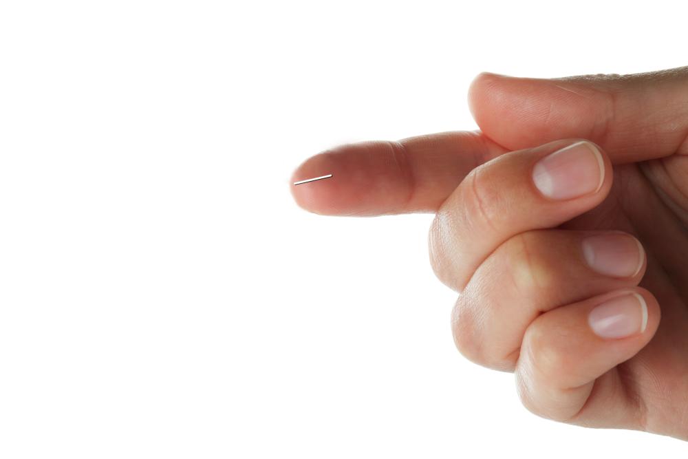 A close-up of a hand with one finger extended. On the finger tip is an image that shows the approximate scale of the gel stent. 