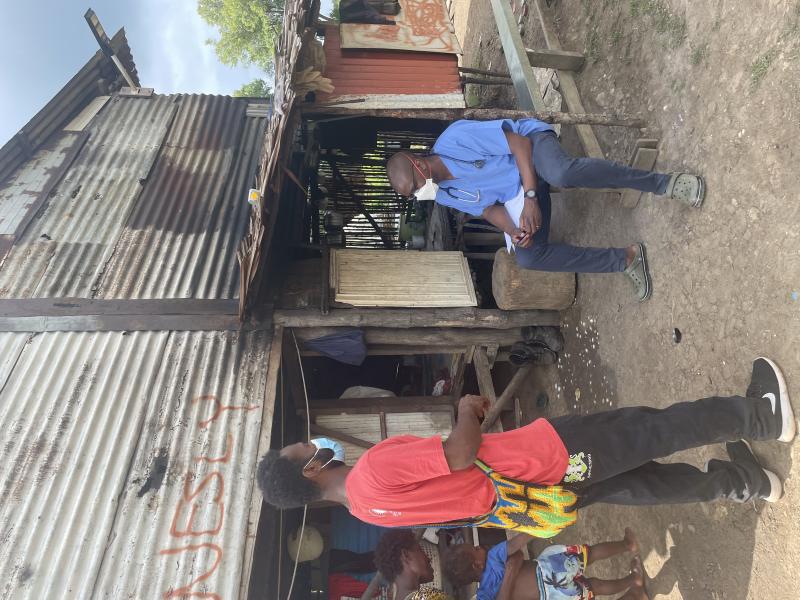 Working with disadvantaged communities in Papua New Guinea. Dr Tafireyi Marukutira with a counsellor following up children on tuberculosis preventive care. 