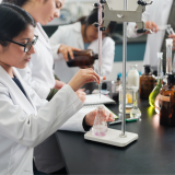 Female researcher in a lab performing an experiment