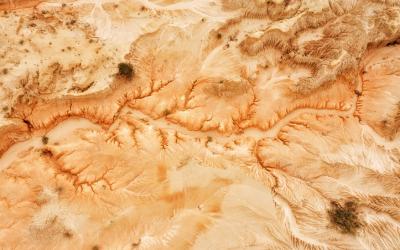 roded dry lake Mungo bed in Australian outback national park - sandstone and clay formation after wind and water erosion in aerial top down view