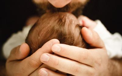 father kissing baby